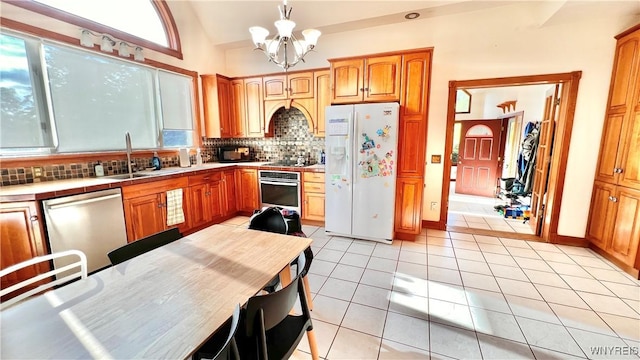 7320 E Flats Rd, East Otto, NY 14729 - kitchen with appliances with stainless steel finishes, a chandelier, tile countertops, backsplash, and plenty of natural light