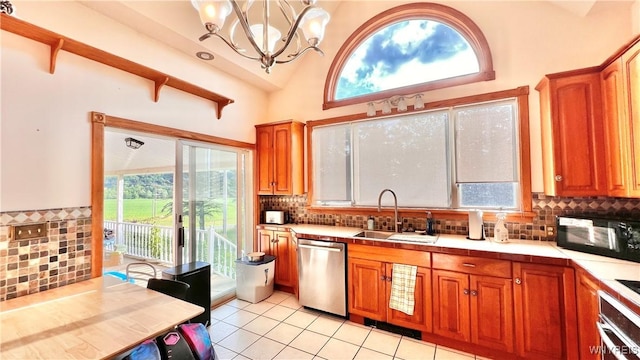 7320 E Flats Rd, East Otto, NY 14729 - kitchen featuring stainless steel appliances, a chandelier, light countertops, tasteful backsplash, and light tile patterned floors