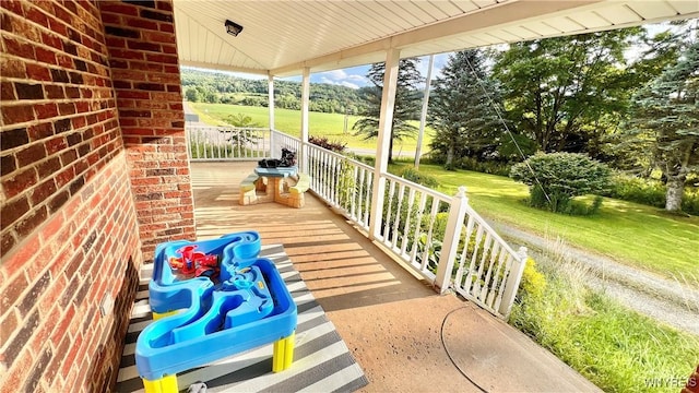 7320 E Flats Rd, East Otto, NY 14729 - covered porch with view of wooded area and a lawn