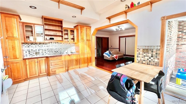 7320 E Flats Rd, East Otto, NY 14729 - kitchen featuring open shelves, tasteful backsplash, tile countertops, glass insert cabinets, and light tile patterned floors