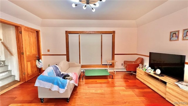 7320 E Flats Rd, East Otto, NY 14729 - living room with wood finished floors, stairs, and a chandelier