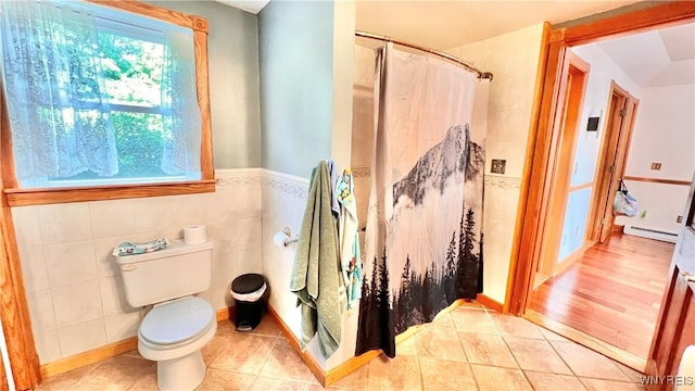 7320 E Flats Rd, East Otto, NY 14729 - full bath featuring a baseboard radiator, a shower with curtain, tile patterned floors, tile walls, and wainscoting