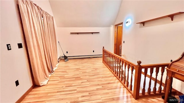 7320 E Flats Rd, East Otto, NY 14729 - corridor with baseboard heating, an upstairs landing, light wood finished floors, vaulted ceiling, and a baseboard heating unit