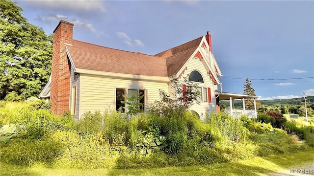 7320 E Flats Rd, East Otto, NY 14729 - view of front facade with a chimney and a shingled roof