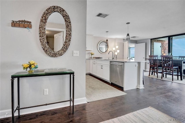 803 Admirals Walk Unit 803, Buffalo, NY 14202 - kitchen with stainless steel dishwasher, white cabinets, dark wood finished floors, a chandelier, and decorative light fixtures