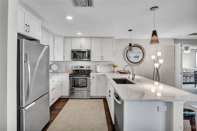 803 Admirals Walk Unit 803, Buffalo, NY 14202 - kitchen featuring stainless steel appliances, a peninsula, dark wood-style floors, white cabinetry, and recessed lighting