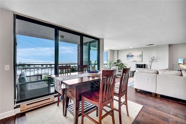 803 Admirals Walk Unit 803, Buffalo, NY 14202 - dining area with wood finished floors, recessed lighting, a baseboard radiator, a wall of windows, and a water view