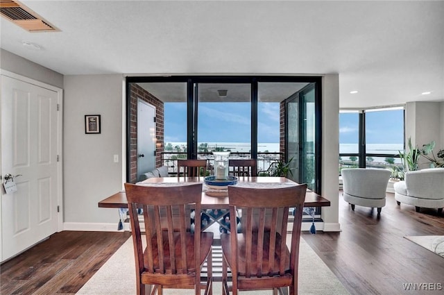 803 Admirals Walk Unit 803, Buffalo, NY 14202 - dining room with wood finished floors, healthy amount of natural light, a wall of windows, and recessed lighting