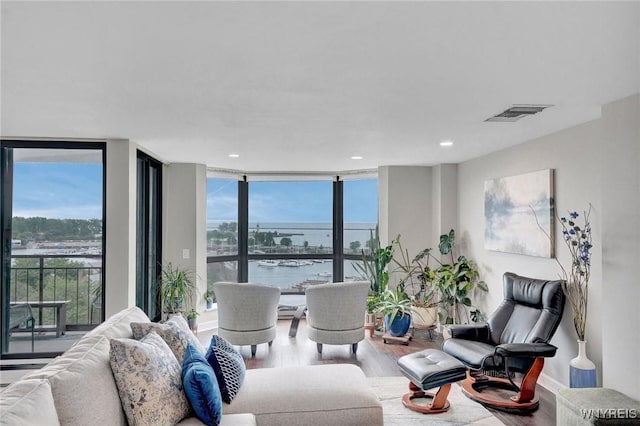 803 Admirals Walk Unit 803, Buffalo, NY 14202 - living room with wood finished floors, floor to ceiling windows, a water view, and recessed lighting