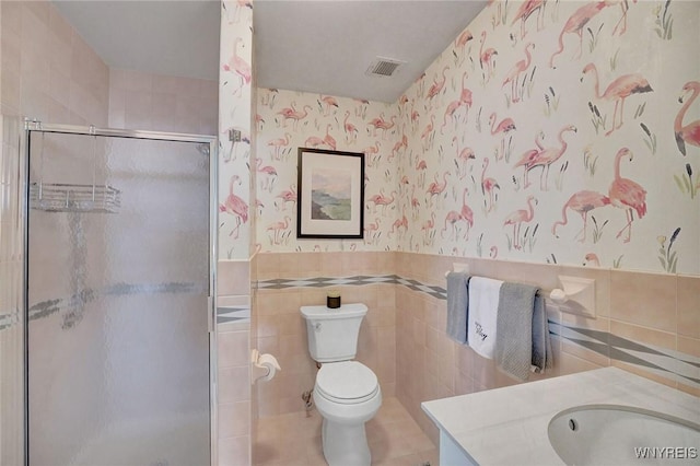 803 Admirals Walk Unit 803, Buffalo, NY 14202 - bathroom featuring vanity, tile walls, a stall shower, wallpapered walls, and wainscoting
