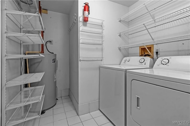 803 Admirals Walk Unit 803, Buffalo, NY 14202 - laundry room featuring independent washer and dryer, water heater, and light tile patterned flooring
