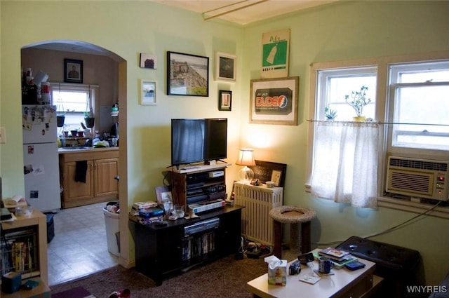 184 Goundry St, North Tonawanda, NY 14120 - living room with arched walkways, tile patterned floors, and cooling unit