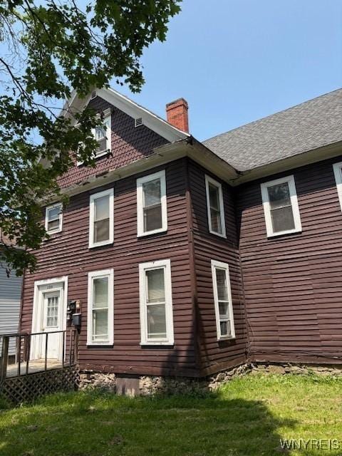 184 Goundry St, North Tonawanda, NY 14120 - back of house featuring a chimney and a lawn