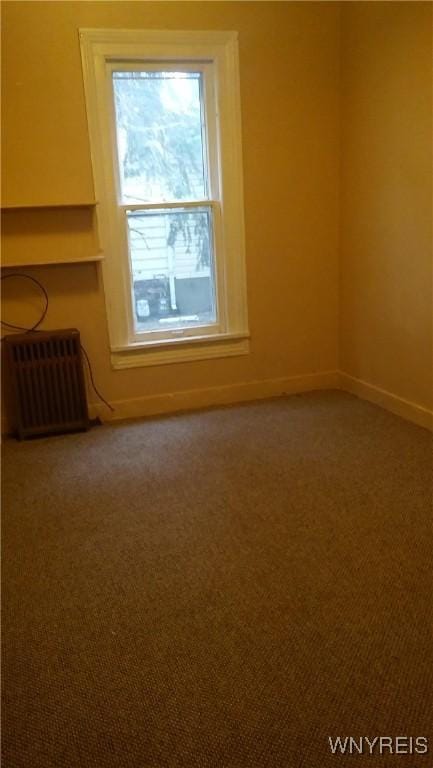 184 Goundry St, North Tonawanda, NY 14120 - spare room featuring radiator heating unit and carpet floors