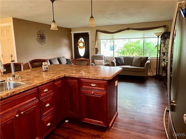 206 Wembridge Dr, Dewitt, NY 13057 - kitchen featuring reddish brown cabinets, a breakfast bar, dark wood-type flooring, and light countertops