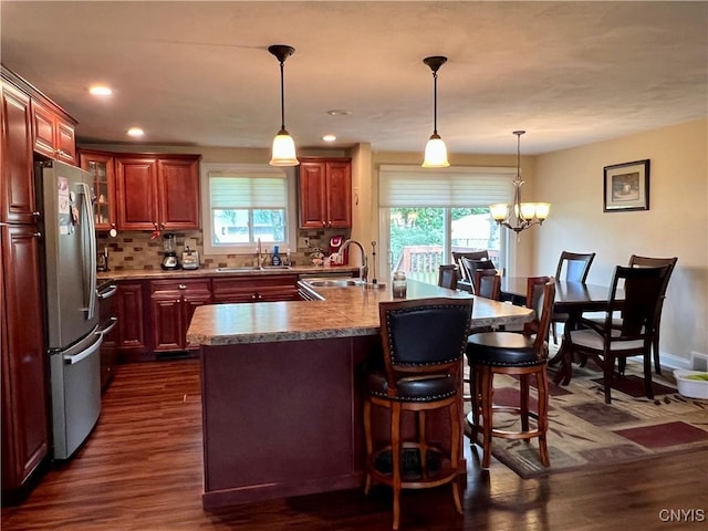 206 Wembridge Dr, Dewitt, NY 13057 - kitchen featuring healthy amount of natural light, dark wood-style flooring, freestanding refrigerator, a kitchen bar, and recessed lighting