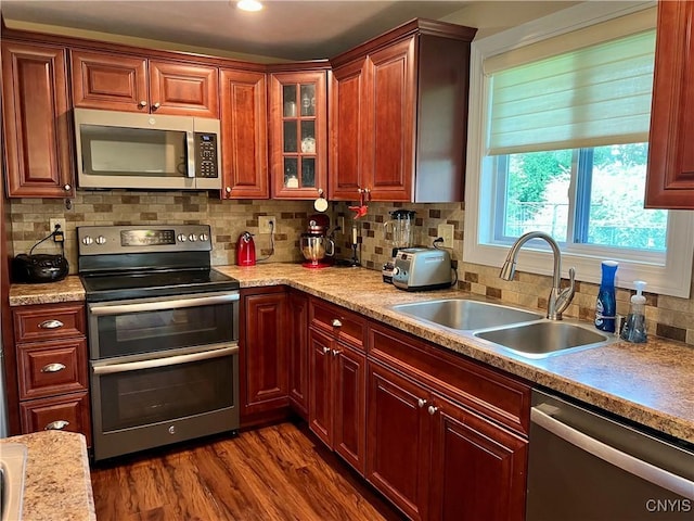 206 Wembridge Dr, Dewitt, NY 13057 - kitchen with stainless steel appliances, decorative backsplash, light countertops, dark wood-style floors, and recessed lighting