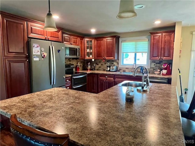 206 Wembridge Dr, Dewitt, NY 13057 - kitchen with appliances with stainless steel finishes, backsplash, hanging light fixtures, glass insert cabinets, and a breakfast bar area