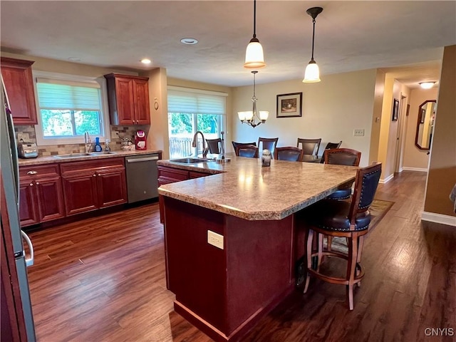 206 Wembridge Dr, Dewitt, NY 13057 - kitchen with stainless steel dishwasher, a breakfast bar, dark wood-style floors, plenty of natural light, and recessed lighting