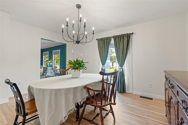 124 Morgan Ln, Oneida, NY 13421 - dining area featuring a chandelier and light wood-style flooring