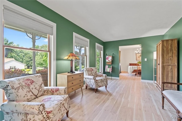 124 Morgan Ln, Oneida, NY 13421 - living area featuring light wood finished floors and a chandelier
