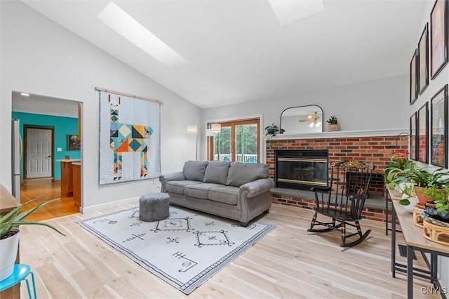 124 Morgan Ln, Oneida, NY 13421 - living area with a skylight, lofted ceiling, wood finished floors, and a fireplace