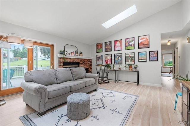 124 Morgan Ln, Oneida, NY 13421 - living room with a skylight, a brick fireplace, light wood-style flooring, and high vaulted ceiling