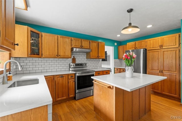 124 Morgan Ln, Oneida, NY 13421 - kitchen featuring appliances with stainless steel finishes, under cabinet range hood, light wood finished floors, light countertops, and recessed lighting