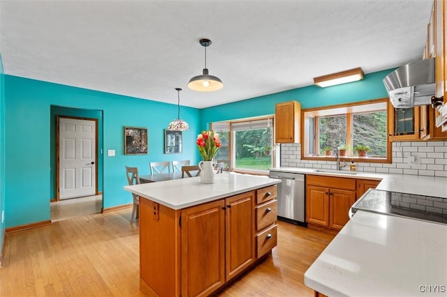 124 Morgan Ln, Oneida, NY 13421 - kitchen with stainless steel dishwasher, extractor fan, decorative backsplash, light countertops, and light wood-type flooring
