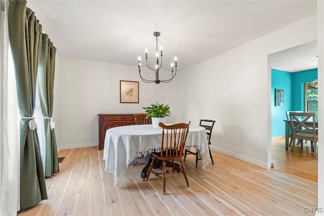124 Morgan Ln, Oneida, NY 13421 - dining space with a chandelier and light wood-style floors