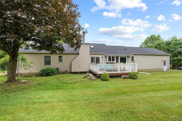 124 Morgan Ln, Oneida, NY 13421 - rear view of house with a wooden deck, a lawn, a chimney, and roof with shingles