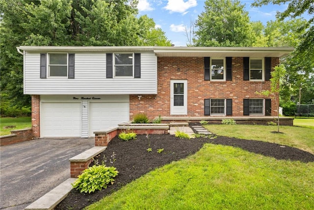 911 Copperkettle Rd, Webster, NY 14580 - split foyer home featuring asphalt driveway, a garage, a front yard, and brick siding