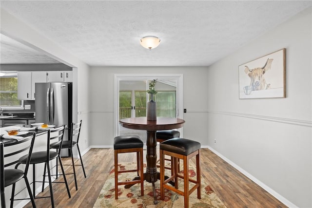 911 Copperkettle Rd, Webster, NY 14580 - dining space with wood finished floors and a textured ceiling