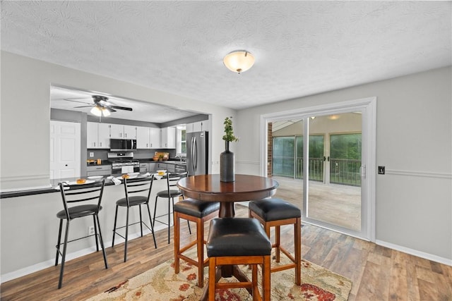 911 Copperkettle Rd, Webster, NY 14580 - dining space featuring plenty of natural light, light wood-style floors, ceiling fan, and a textured ceiling