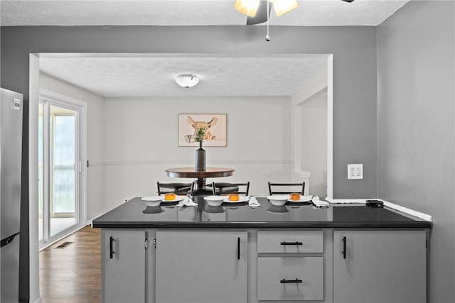 911 Copperkettle Rd, Webster, NY 14580 - bar with freestanding refrigerator and dark wood-style flooring