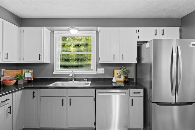 911 Copperkettle Rd, Webster, NY 14580 - kitchen with appliances with stainless steel finishes, dark countertops, and white cabinets