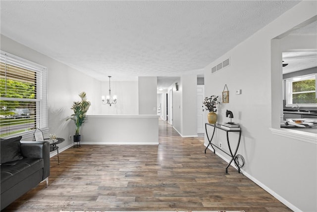 911 Copperkettle Rd, Webster, NY 14580 - living area featuring a chandelier, wood finished floors, and a textured ceiling