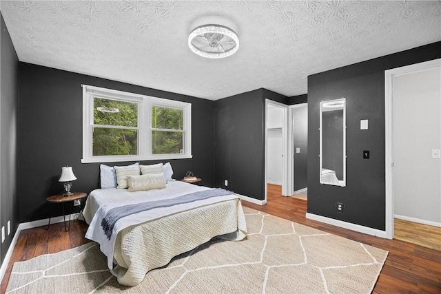 911 Copperkettle Rd, Webster, NY 14580 - bedroom featuring wood finished floors and a textured ceiling