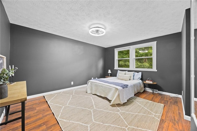 911 Copperkettle Rd, Webster, NY 14580 - bedroom featuring wood finished floors and a textured ceiling