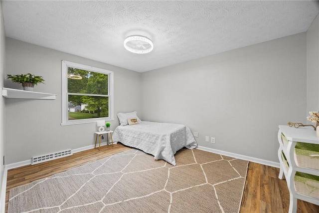 911 Copperkettle Rd, Webster, NY 14580 - bedroom featuring wood finished floors and a textured ceiling