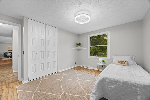 911 Copperkettle Rd, Webster, NY 14580 - bedroom featuring wood finished floors and a closet