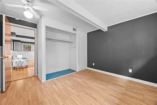 911 Copperkettle Rd, Webster, NY 14580 - unfurnished bedroom with wood finished floors, a closet, a ceiling fan, and a textured ceiling