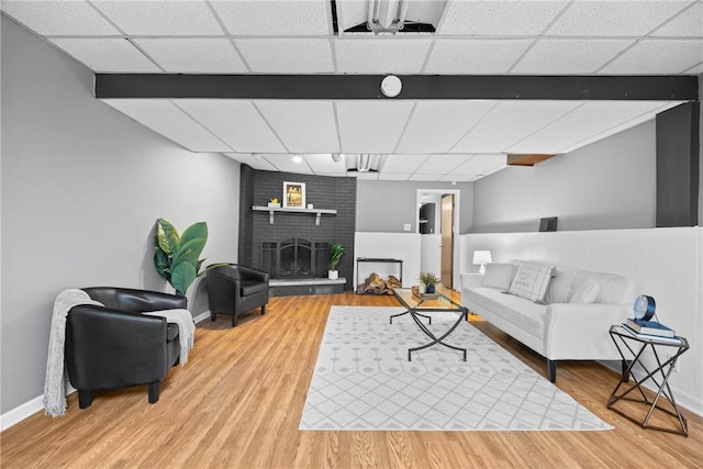 911 Copperkettle Rd, Webster, NY 14580 - living area featuring a paneled ceiling, wood finished floors, and a fireplace