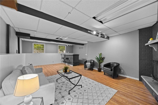 911 Copperkettle Rd, Webster, NY 14580 - living area featuring a drop ceiling, wood finished floors, and bar area