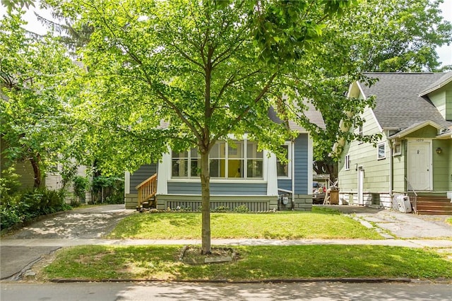 1085 Garson Ave, Rochester, NY 14609 - view of front facade featuring asphalt driveway, entry steps, a front yard, and a shingled roof