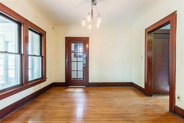 1085 Garson Ave, Rochester, NY 14609 - unfurnished dining area featuring ornamental molding, wood finished floors, and a chandelier