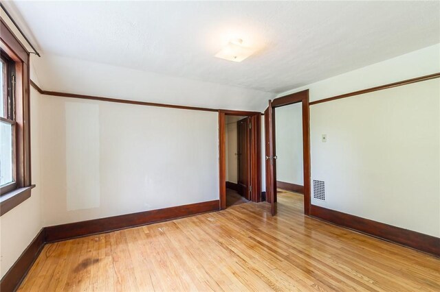 1085 Garson Ave, Rochester, NY 14609 - unfurnished room featuring light wood-style floors and vaulted ceiling