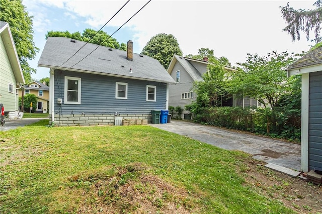 1085 Garson Ave, Rochester, NY 14609 - rear view of house with a chimney and a yard