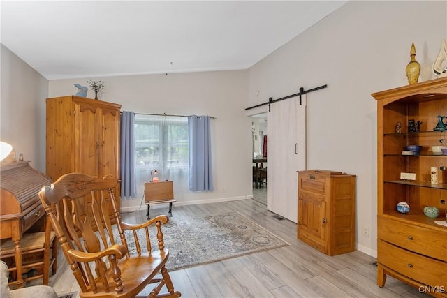 217 Melrose Ave, Camillus, NY 13219 - sitting room featuring a barn door, light wood-style flooring, and high vaulted ceiling