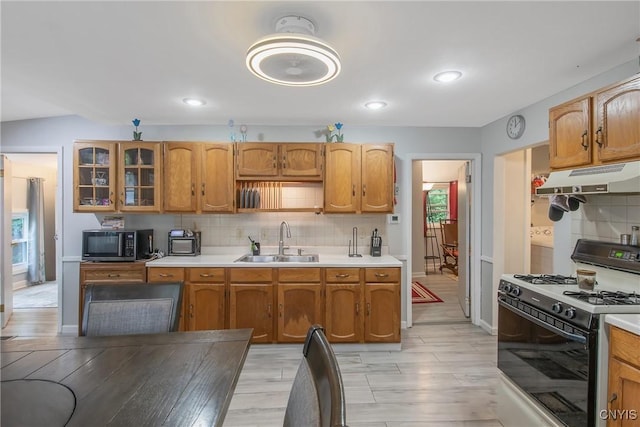 217 Melrose Ave, Camillus, NY 13219 - kitchen featuring white gas range oven, under cabinet range hood, decorative backsplash, light countertops, and recessed lighting